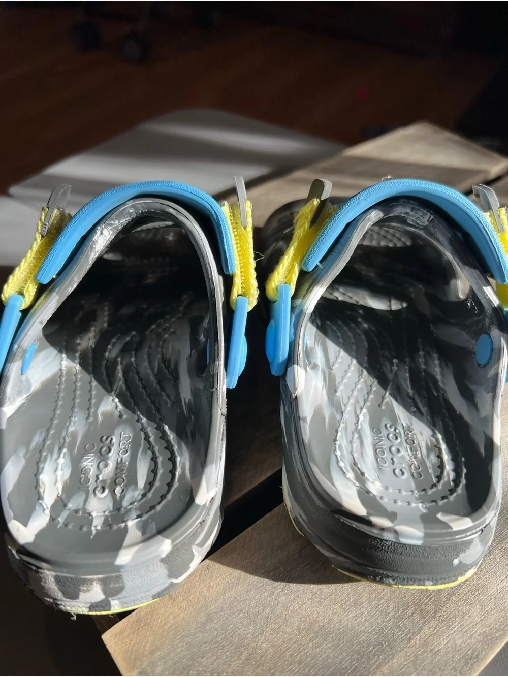CROCS Kids Black Sandals with Blue and Yellow Accents